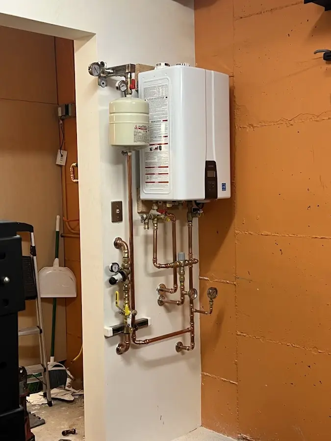 Plumbing technician inspecting water heater connections in Sinking Spring